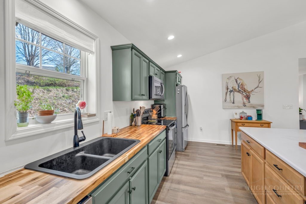 656 Mulatto Mountain Road West Jefferson, NC 28694 - Photo 13 of 35 a kitchen that has a sink and a stove