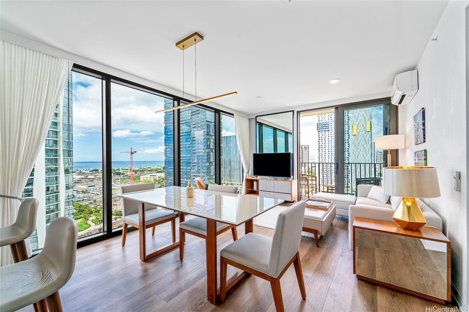 987 Queen Street, Unit 2001 Honolulu, HI 96814 - Photo 3 of 6 a living room with furniture and a large window