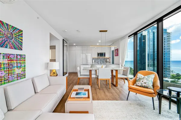 a living room with furniture dining table and a large window