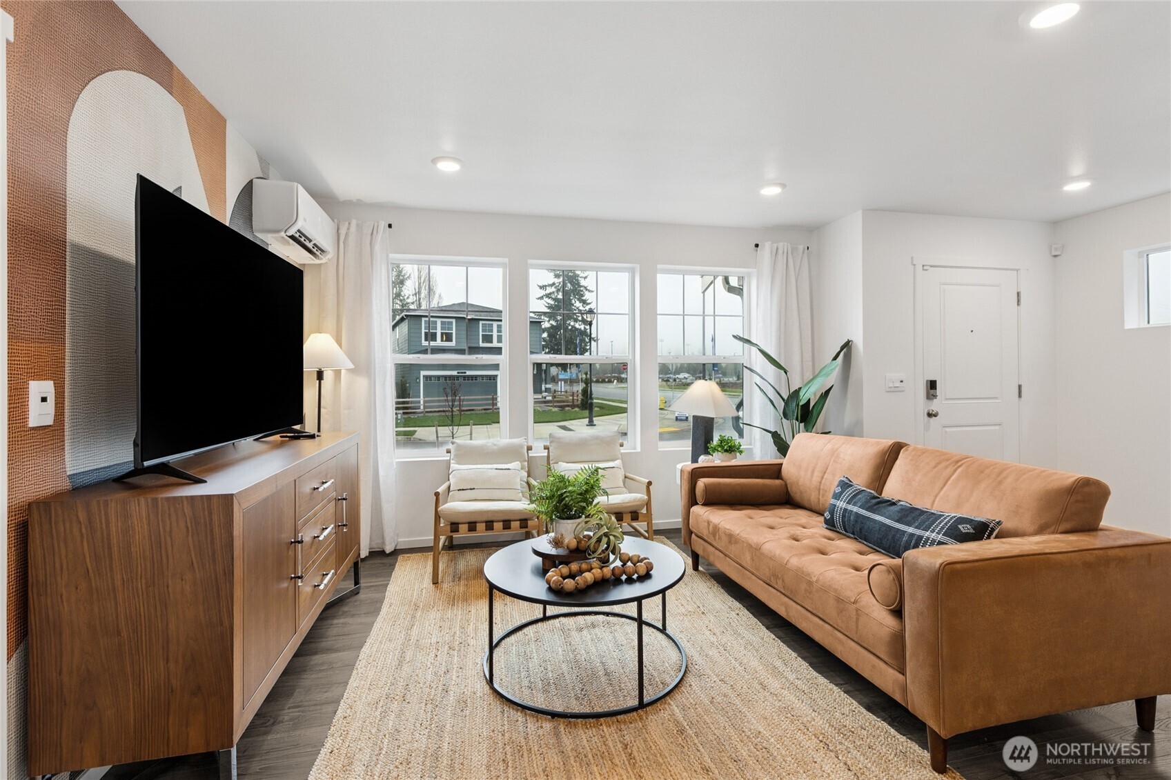 8337 Ostrom Avenue Southeast, Unit 101 Lacey, WA 98513 - Photo 5 of 28 a living room with furniture and a flat screen tv