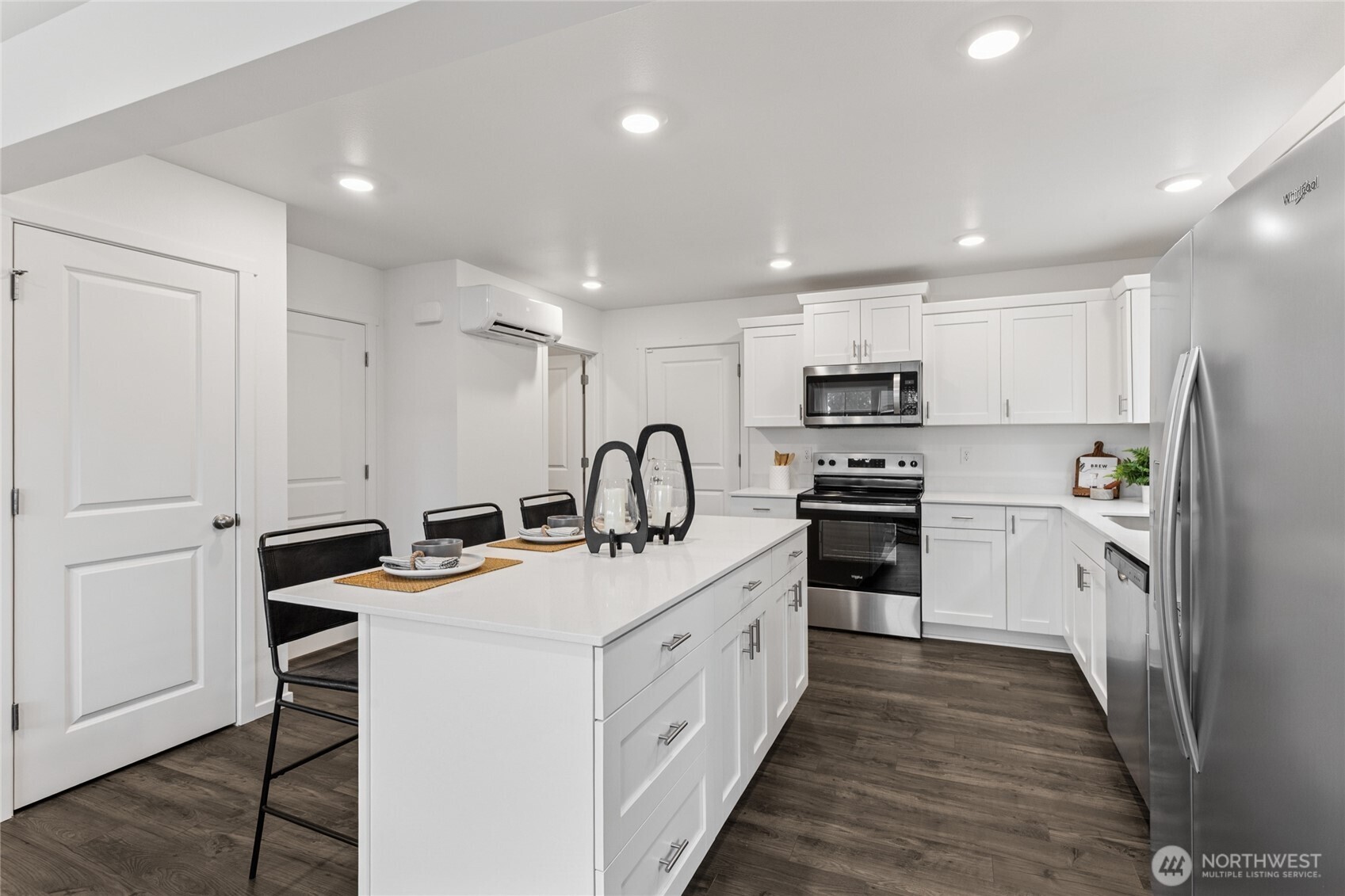 8337 Ostrom Avenue Southeast, Unit 101 Lacey, WA 98513 - Photo 7 of 28 a kitchen with white cabinets and stainless steel appliances