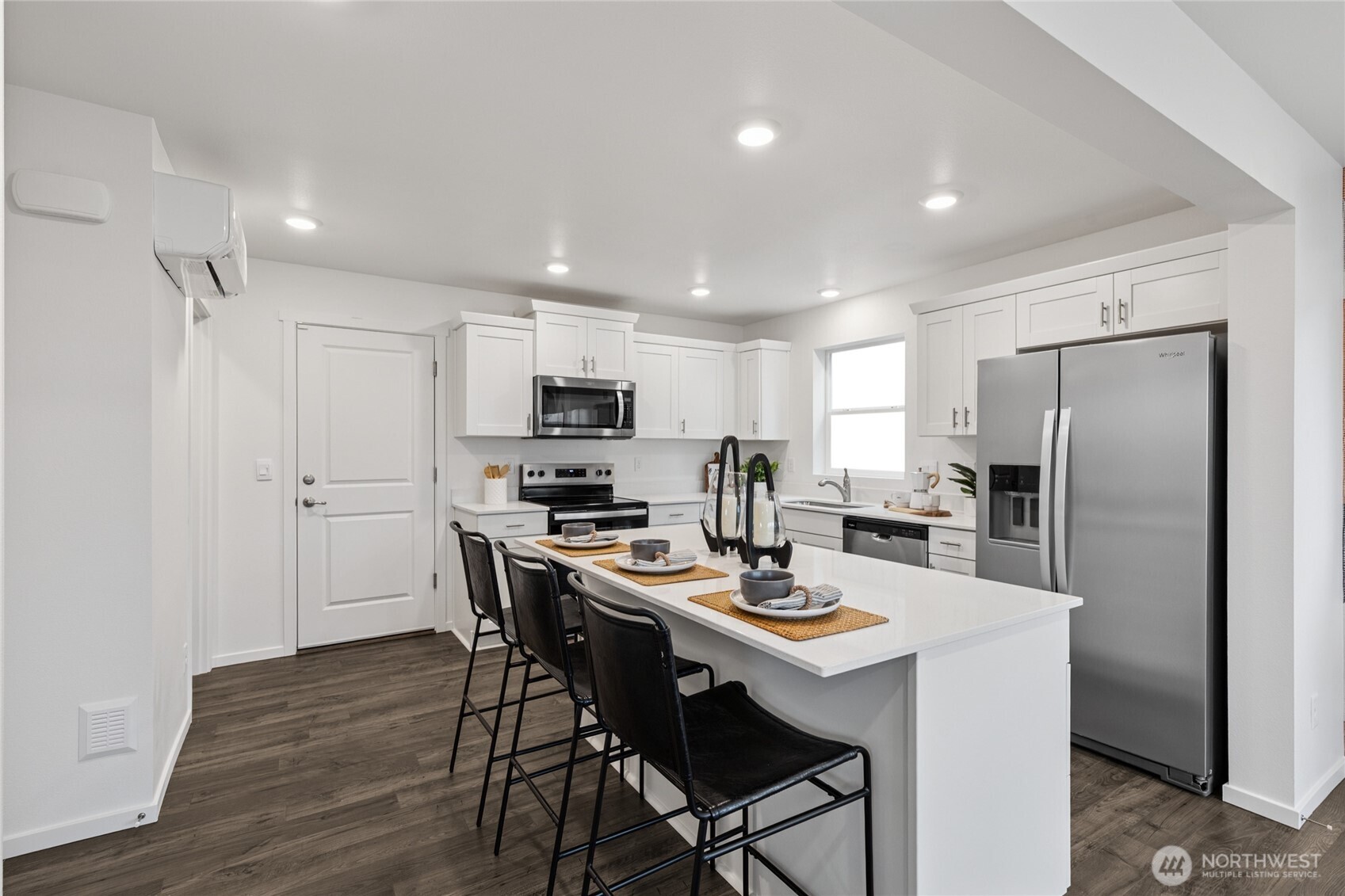 8337 Ostrom Avenue Southeast, Unit 101 Lacey, WA 98513 - Photo 10 of 28 a kitchen with stainless steel appliances a dining table chairs refrigerator and microwave