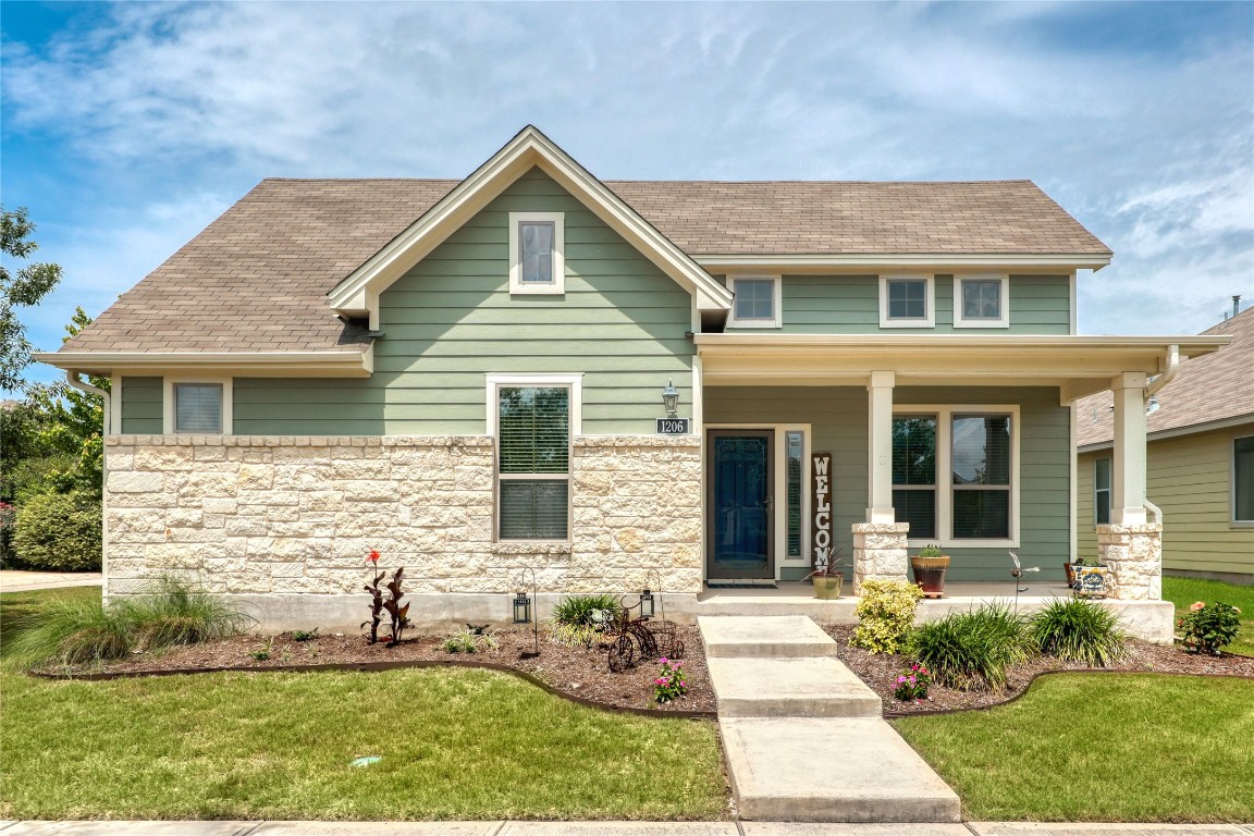a front view of a house with garden