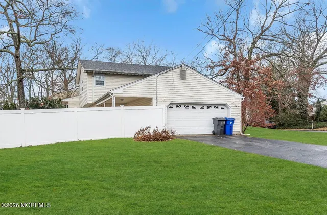 a view of a house with a yard and sitting area