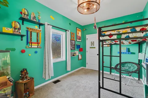 a bedroom with furniture and wooden floor