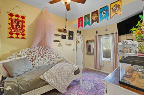 a bedroom with a bed and a chandelier