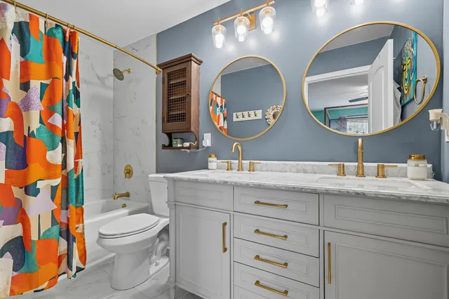 a bathroom with a toilet sink and mirror