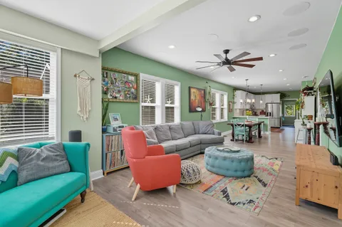 a living room with furniture ceiling fan and a rug