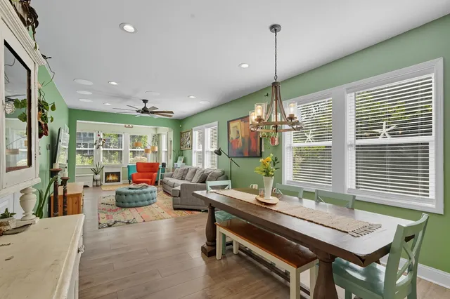 a living room with furniture a window and a chandelier