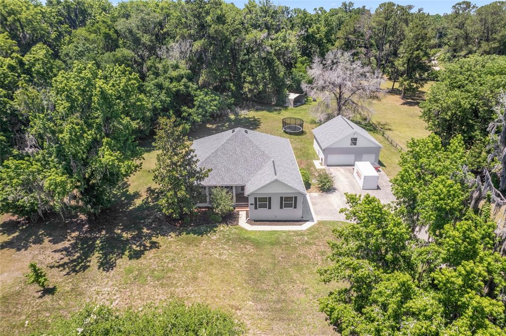 4735 Southeast 112th Street Road Belleview, FL 34420 - Photo 8 of 73 an aerial view of a house with yard swimming pool and outdoor seating
