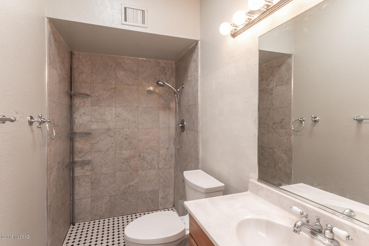 7761 North Rasmussen Avenue Tucson, AZ 85741 - Photo 11 of 23 a bathroom with a toilet and a shower