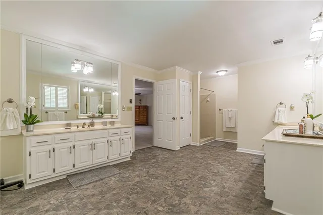 a large bathroom with a double vanity sink and a mirror