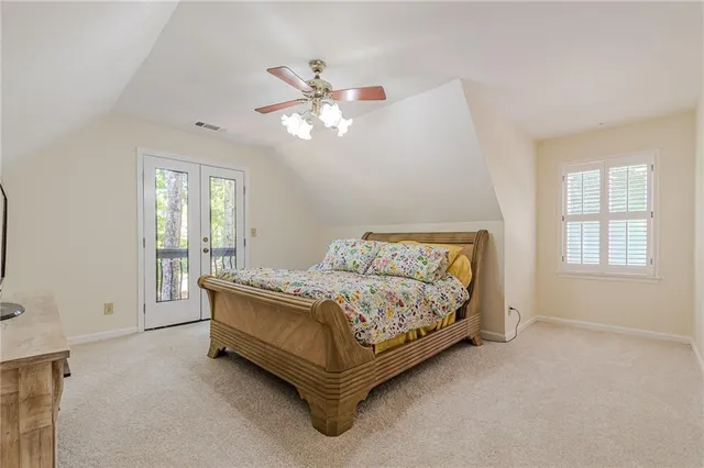 a bed sitting in a bedroom next to a window