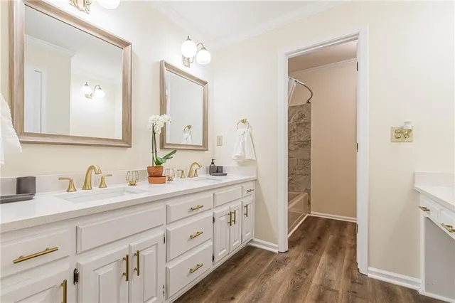a bathroom with double vanity sink and two mirror