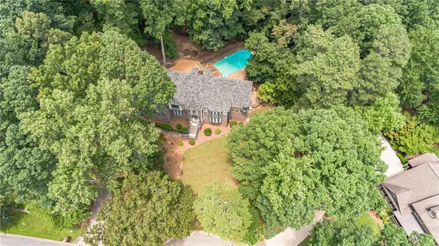 an aerial view of a house with a yard