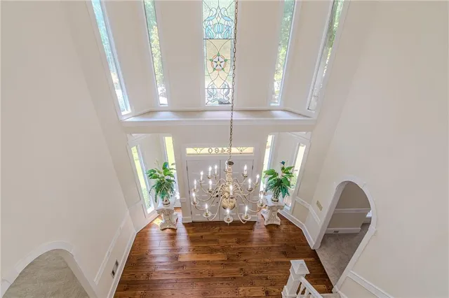 a view of a living room with furniture and a chandelier