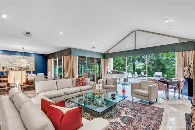 a living room with furniture and a floor to ceiling window