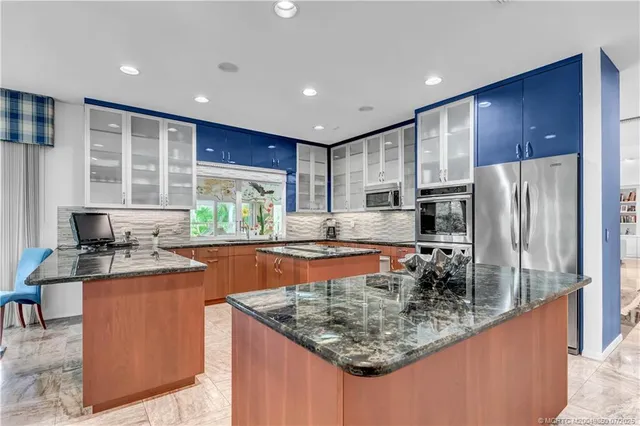 a kitchen with stainless steel appliances granite countertop a stove sink and microwave