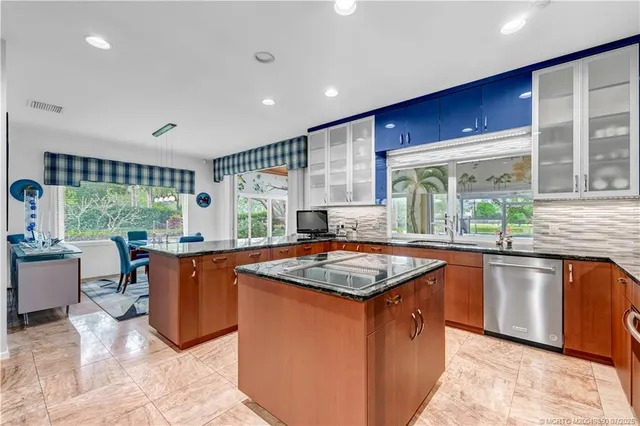 a kitchen with stainless steel appliances granite countertop a sink and a stove