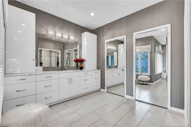 a spacious bathroom with a shower sink and mirror