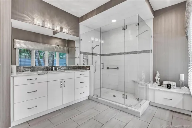 a bathroom with a granite countertop toilet sink and mirror