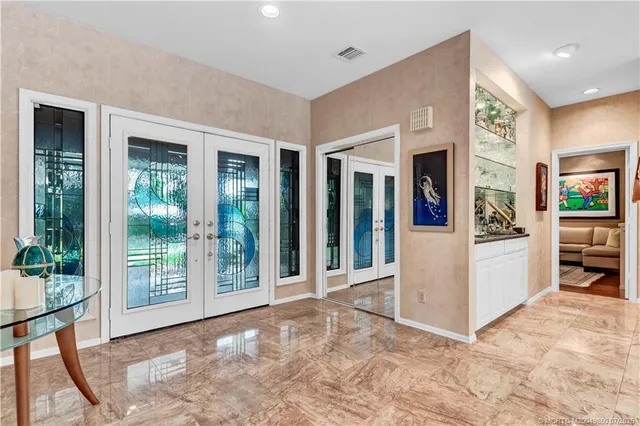 a hallway with sink and mirror