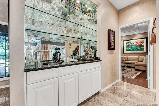a living room with furniture large window and a fireplace