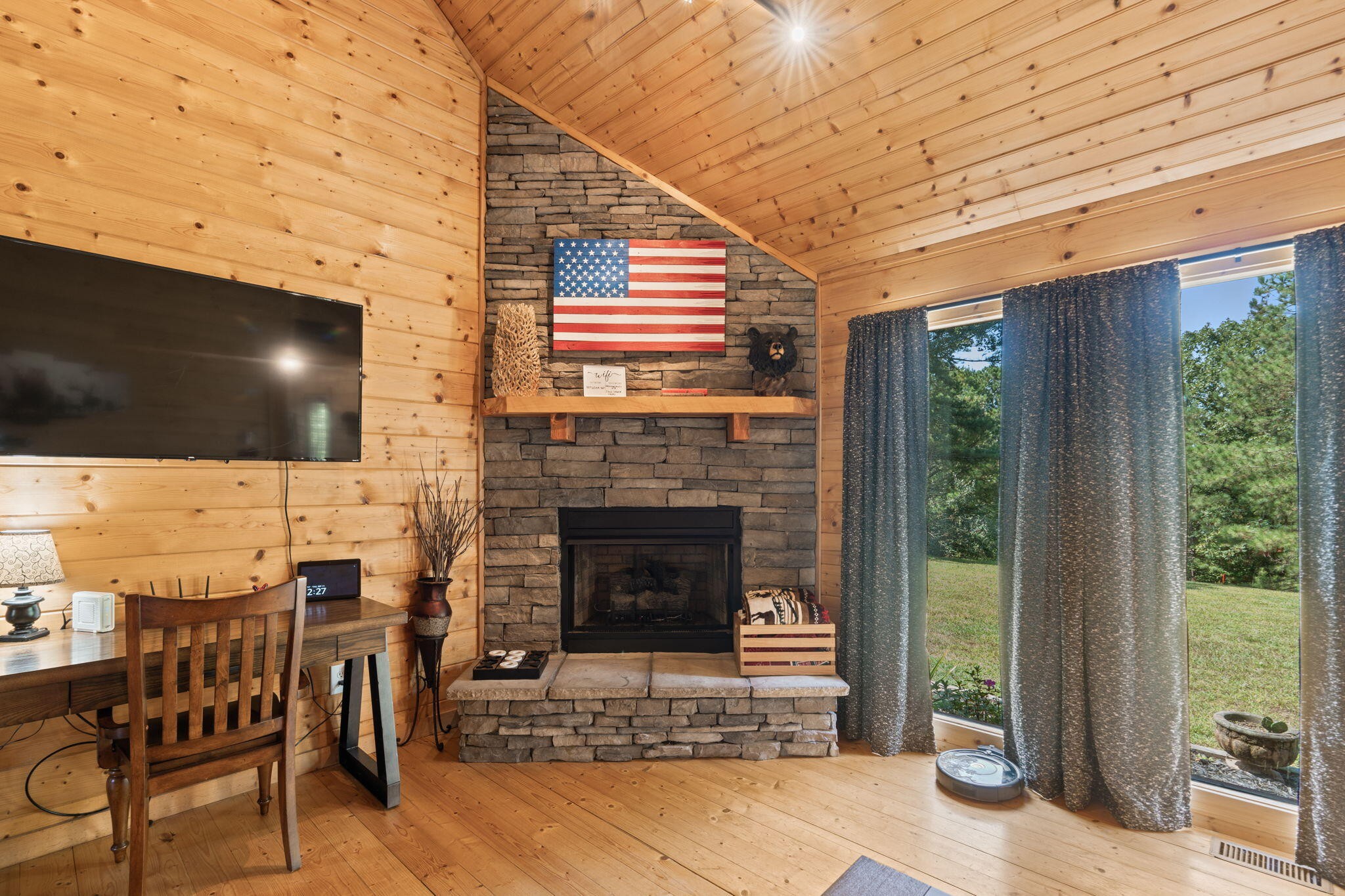 947 Belltown Road Copperhill, TN 37317 - Photo 3 of 26 a living room with patio fireplace and a flat screen tv