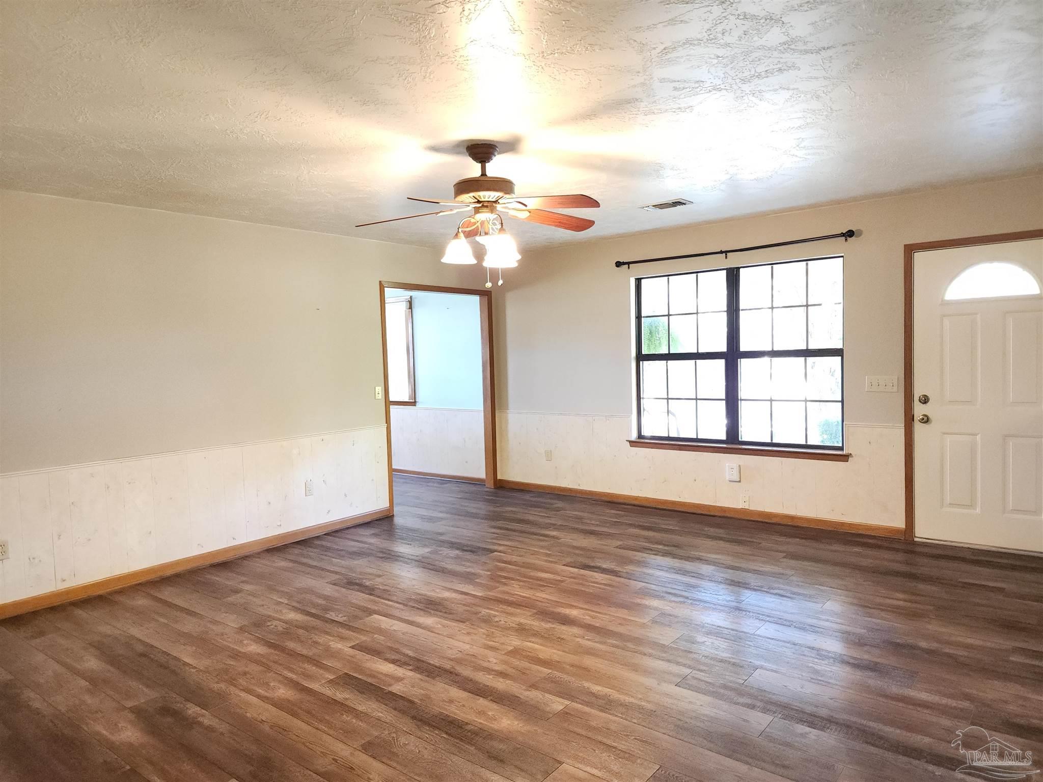 5560 Morgan Road Walnut Hill, FL 32568 - Photo 13 of 63 wooden floor in an empty room with a window