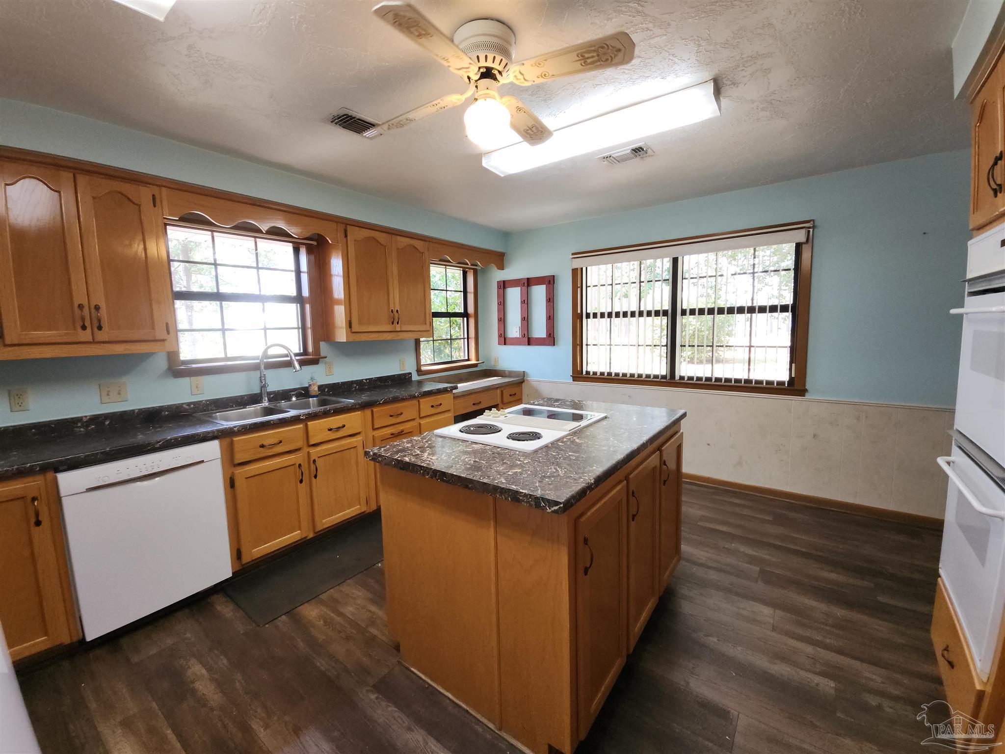 5560 Morgan Road Walnut Hill, FL 32568 - Photo 14 of 63 a kitchen with a stove and a sink