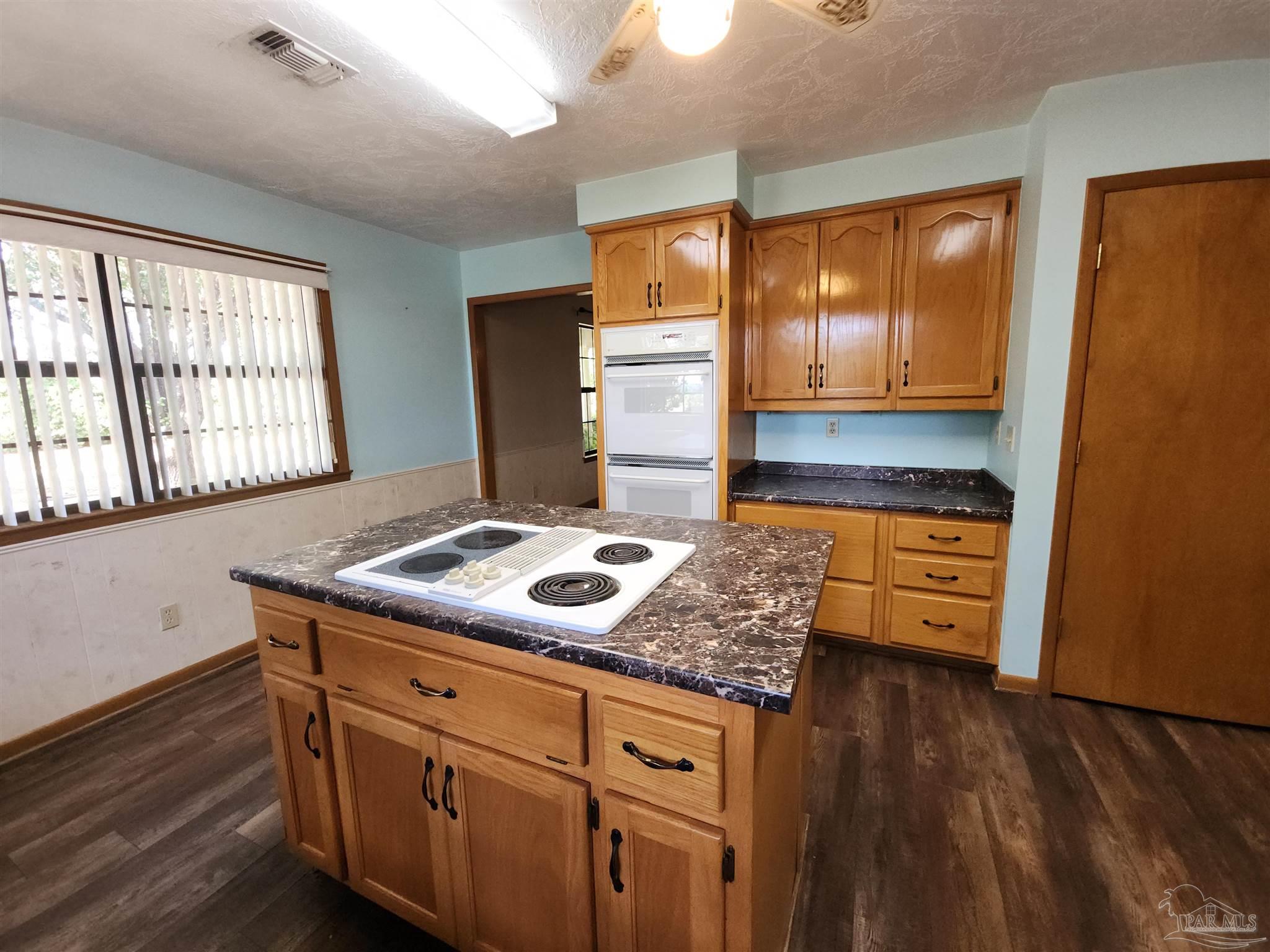 5560 Morgan Road Walnut Hill, FL 32568 - Photo 17 of 63 a kitchen with stainless steel appliances granite countertop a stove a sink and a refrigerator