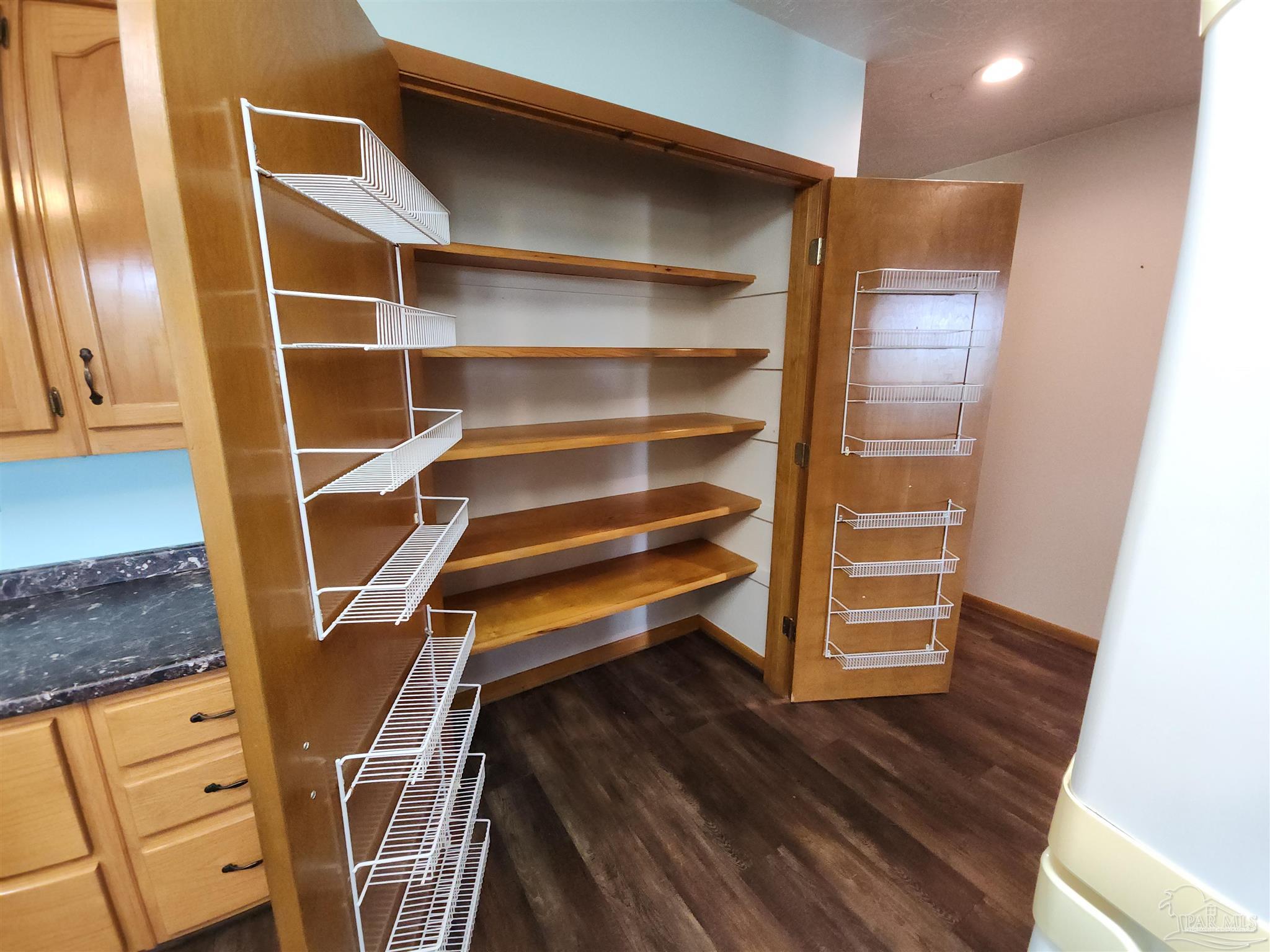 5560 Morgan Road Walnut Hill, FL 32568 - Photo 19 of 63 a view of an empty room with wooden floor and a window