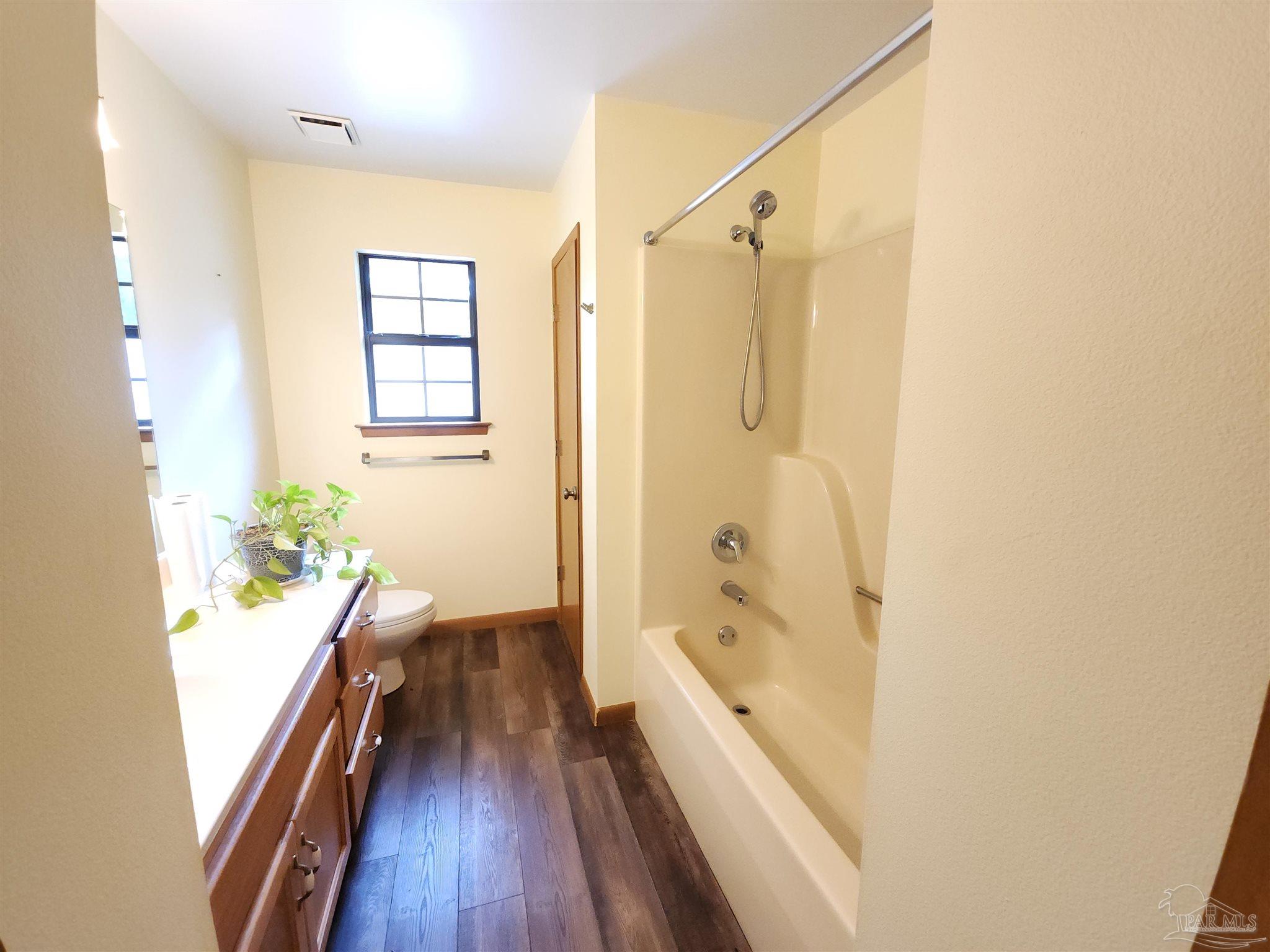 5560 Morgan Road Walnut Hill, FL 32568 - Photo 20 of 63 a bathroom with a bathtub and a shower