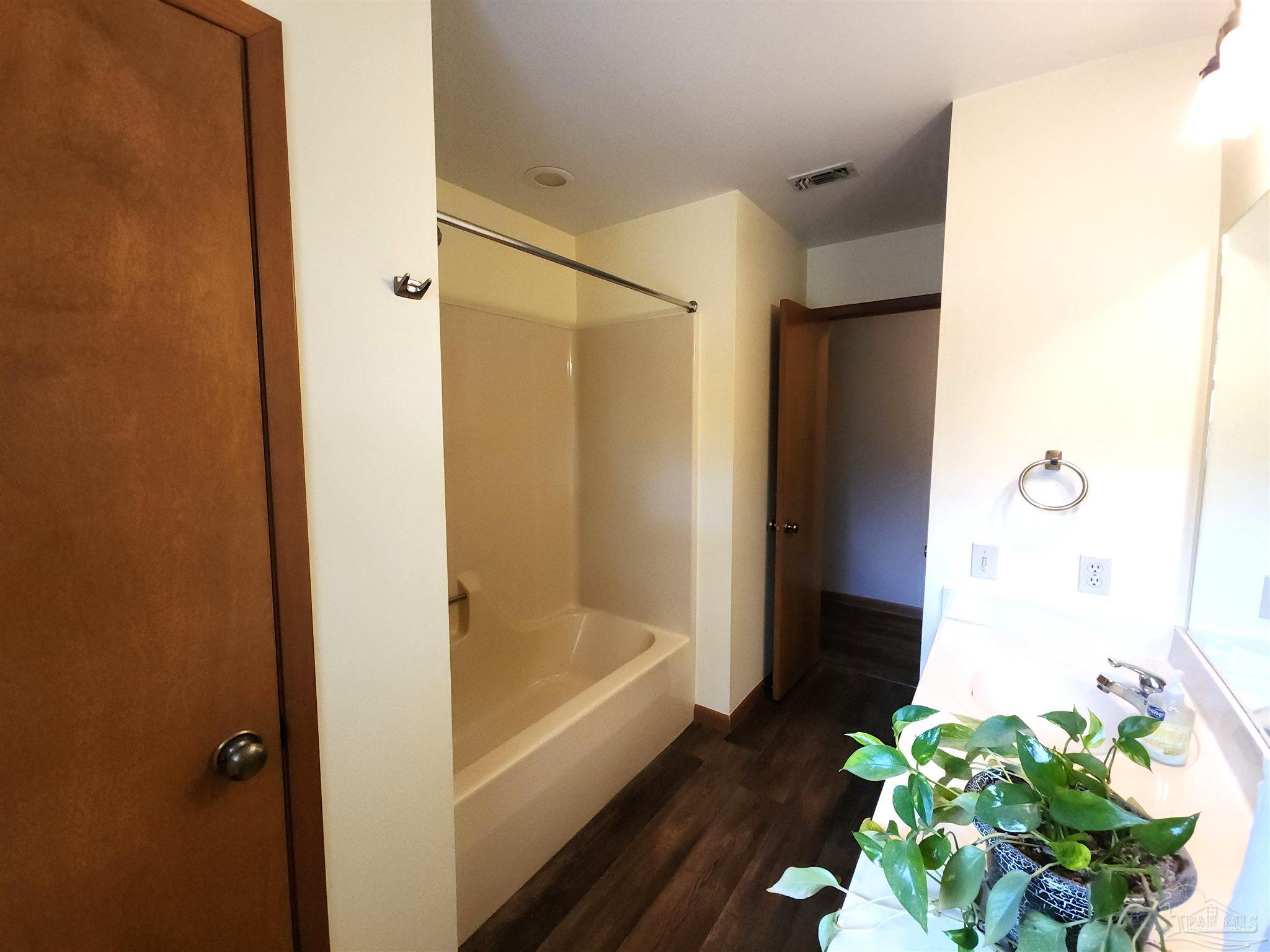 5560 Morgan Road Walnut Hill, FL 32568 - Photo 22 of 63 a bathroom with a bathtub