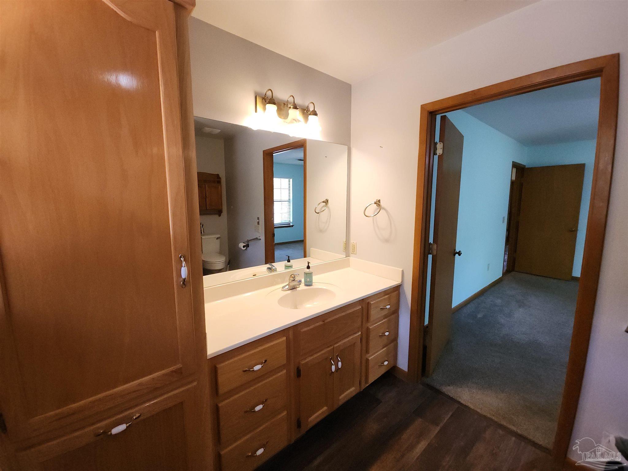 5560 Morgan Road Walnut Hill, FL 32568 - Photo 32 of 63 a spacious bathroom with a double vanity sink and a mirror