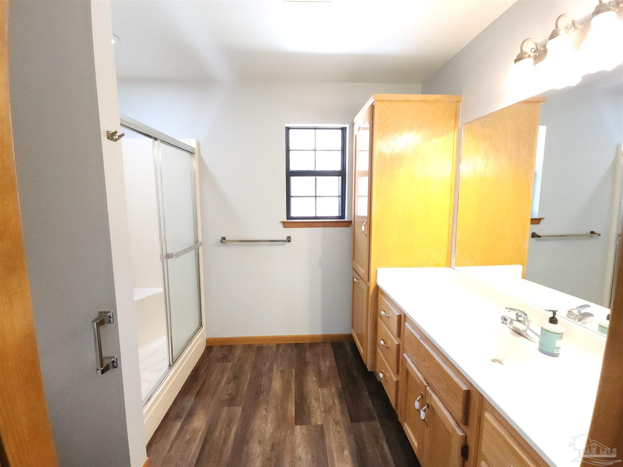 5560 Morgan Road Walnut Hill, FL 32568 - Photo 35 of 63 a bathroom with a tub sink and a mirror