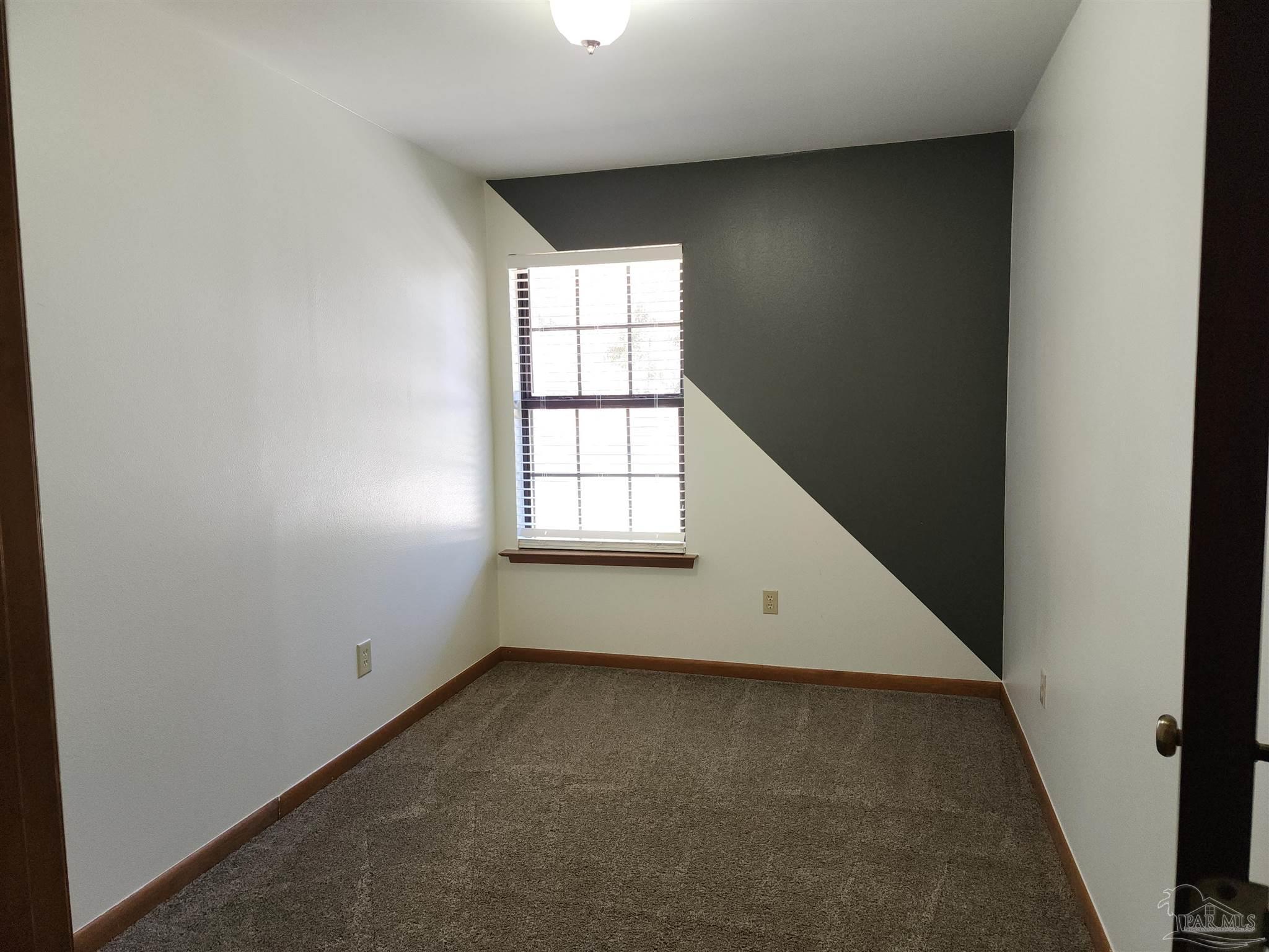 5560 Morgan Road Walnut Hill, FL 32568 - Photo 39 of 63 an empty room with windows