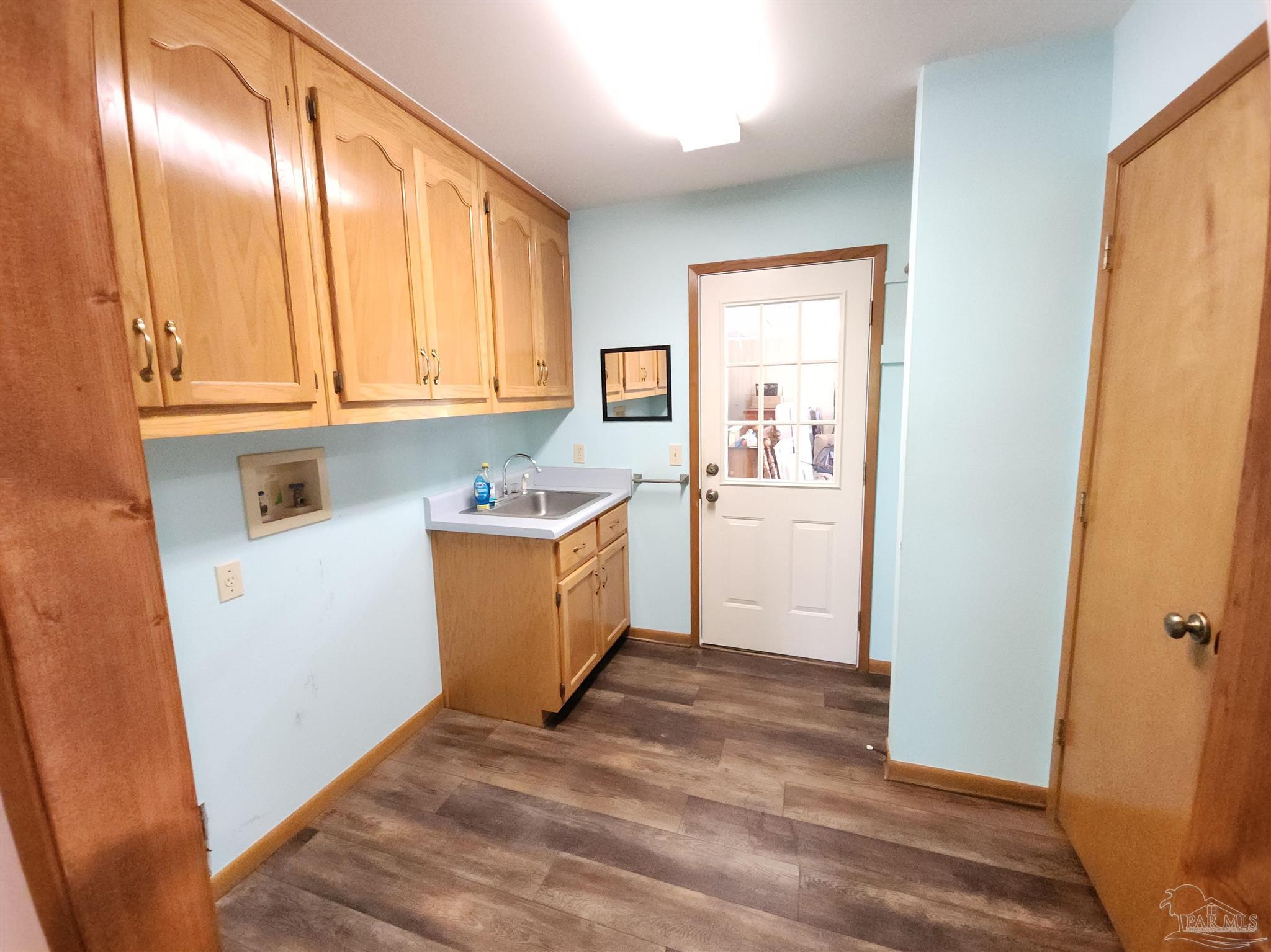 5560 Morgan Road Walnut Hill, FL 32568 - Photo 42 of 63 a view of a kitchen with wooden floor and electronic appliances