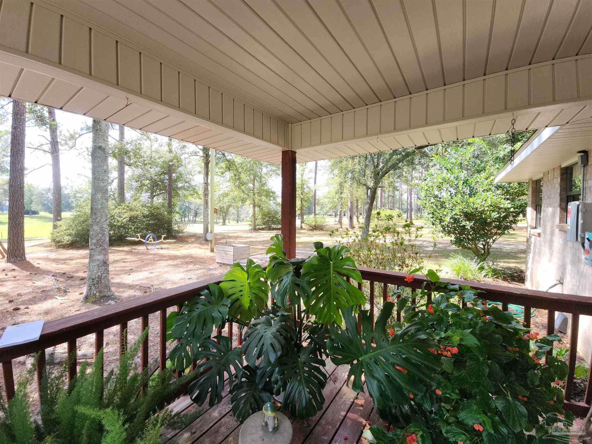 5560 Morgan Road Walnut Hill, FL 32568 - Photo 46 of 63 a view of a porch and garden