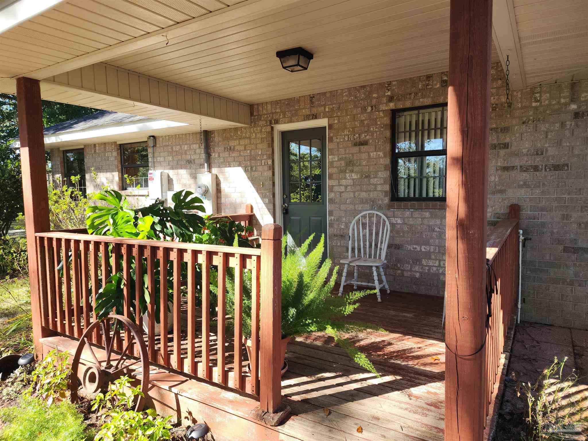 5560 Morgan Road Walnut Hill, FL 32568 - Photo 50 of 63 a front view of a house with a porch