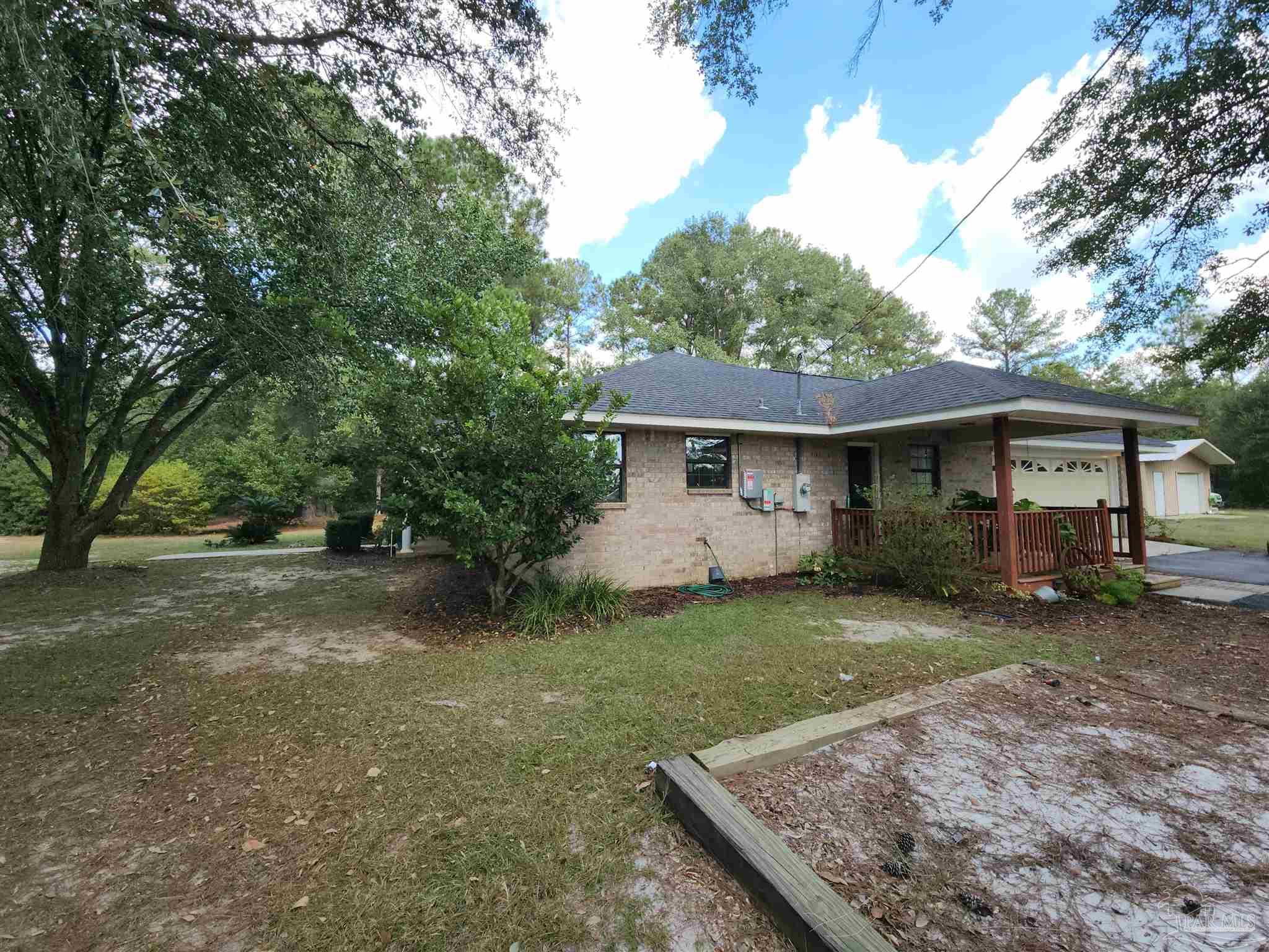 5560 Morgan Road Walnut Hill, FL 32568 - Photo 51 of 63 a view of a yard in front of a house with large tree