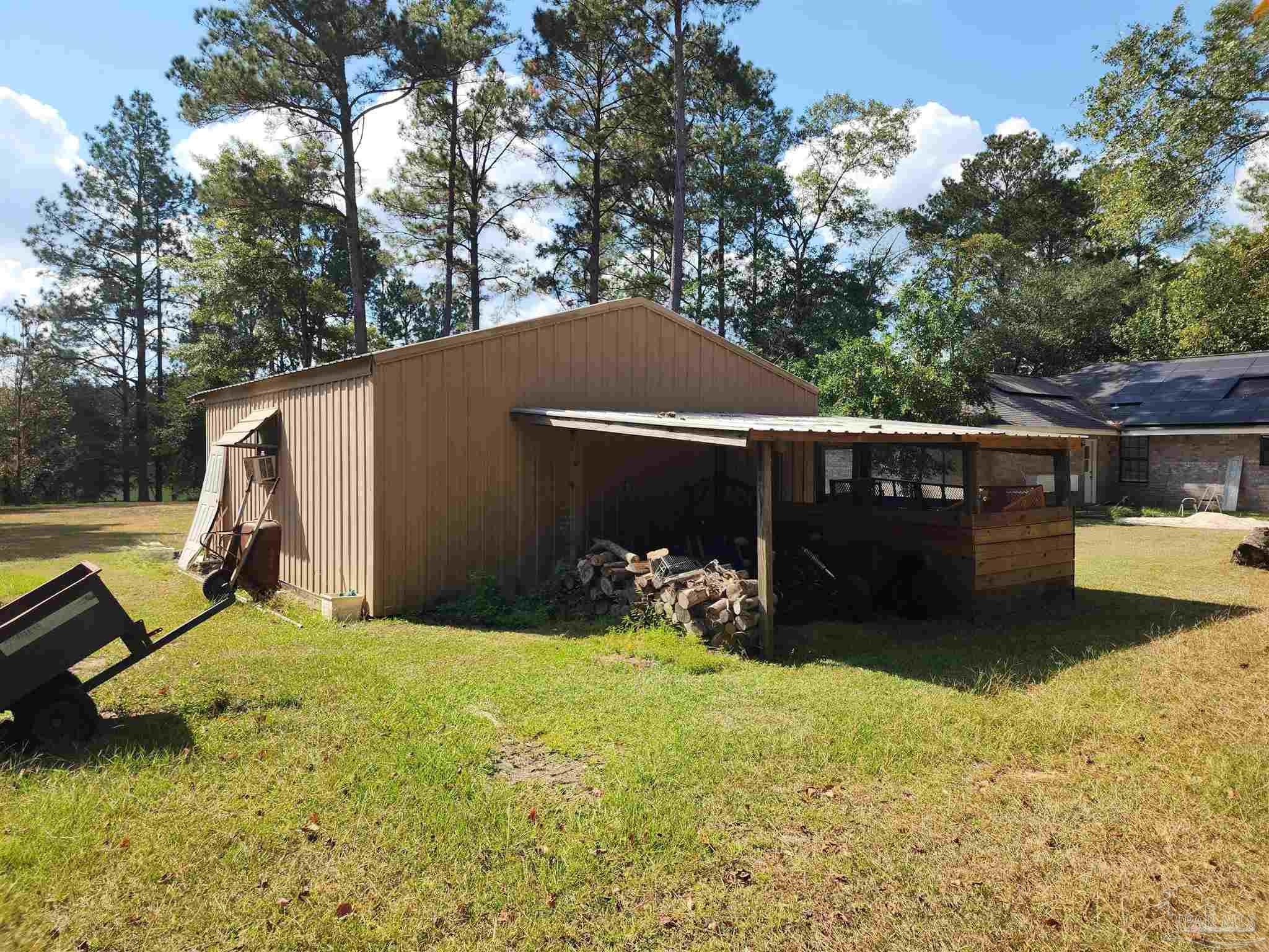 5560 Morgan Road Walnut Hill, FL 32568 - Photo 55 of 63 a view of a backyard with a sitting area