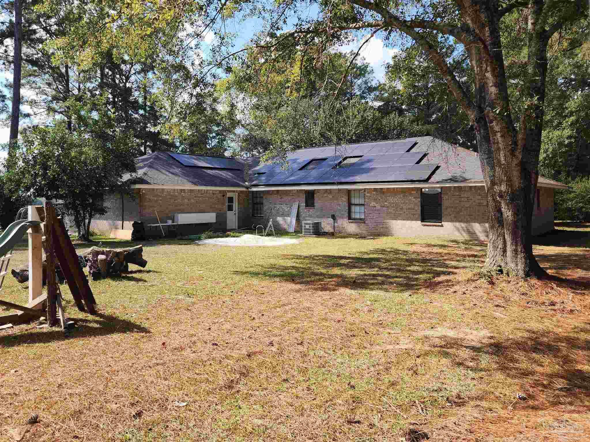 5560 Morgan Road Walnut Hill, FL 32568 - Photo 8 of 63 a front view of a house with a yard
