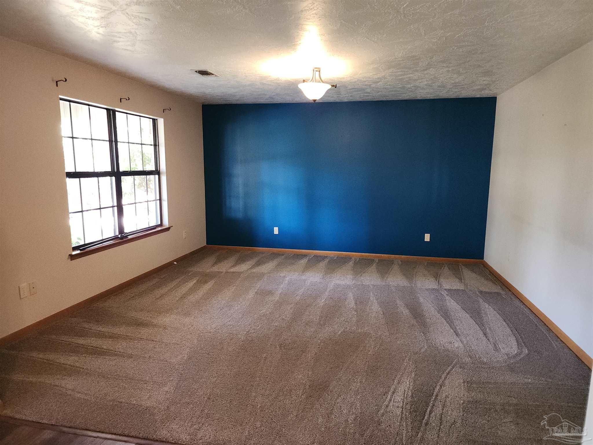 5560 Morgan Road Walnut Hill, FL 32568 - Photo 10 of 63 an empty room with windows