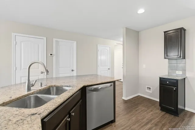 a kitchen with sink cabinets and wooden floor