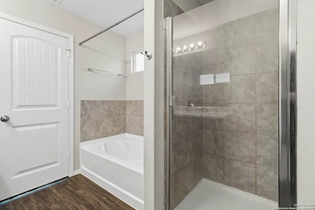a bathroom with a bathtub and shower