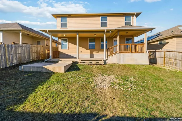 a view of a house with wooden fence