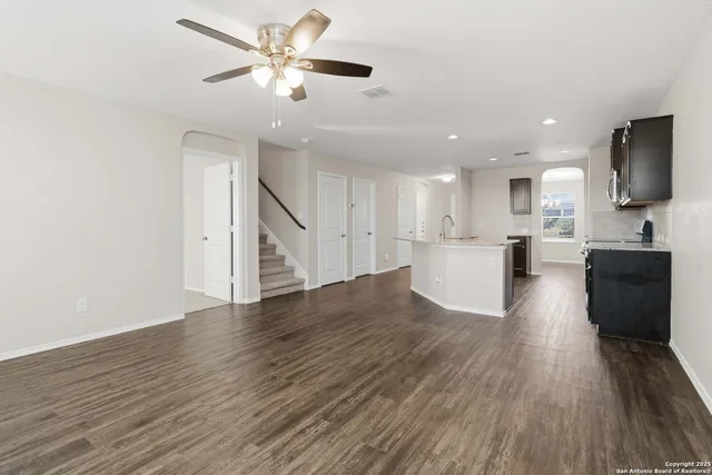 a view of a kitchen with a sink and a refrigerator