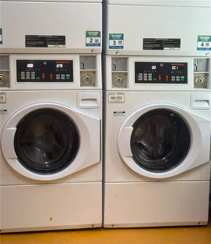 a living room with dining table and a flat screen tv