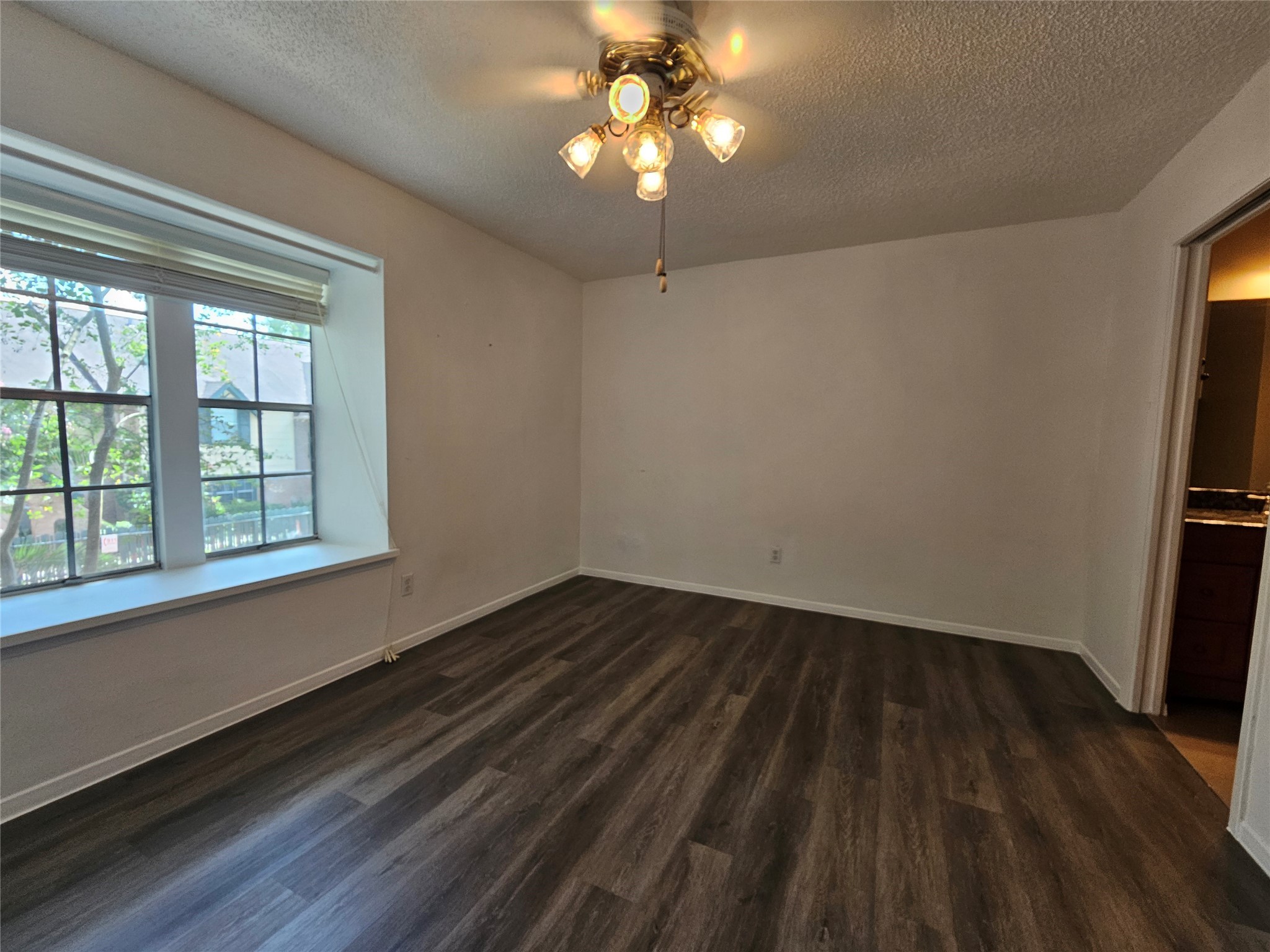 8287 Kingsbrook Road, Unit 268 Houston, TX 77024 - Photo 14 of 50 a view of an empty room with wooden floor and a window